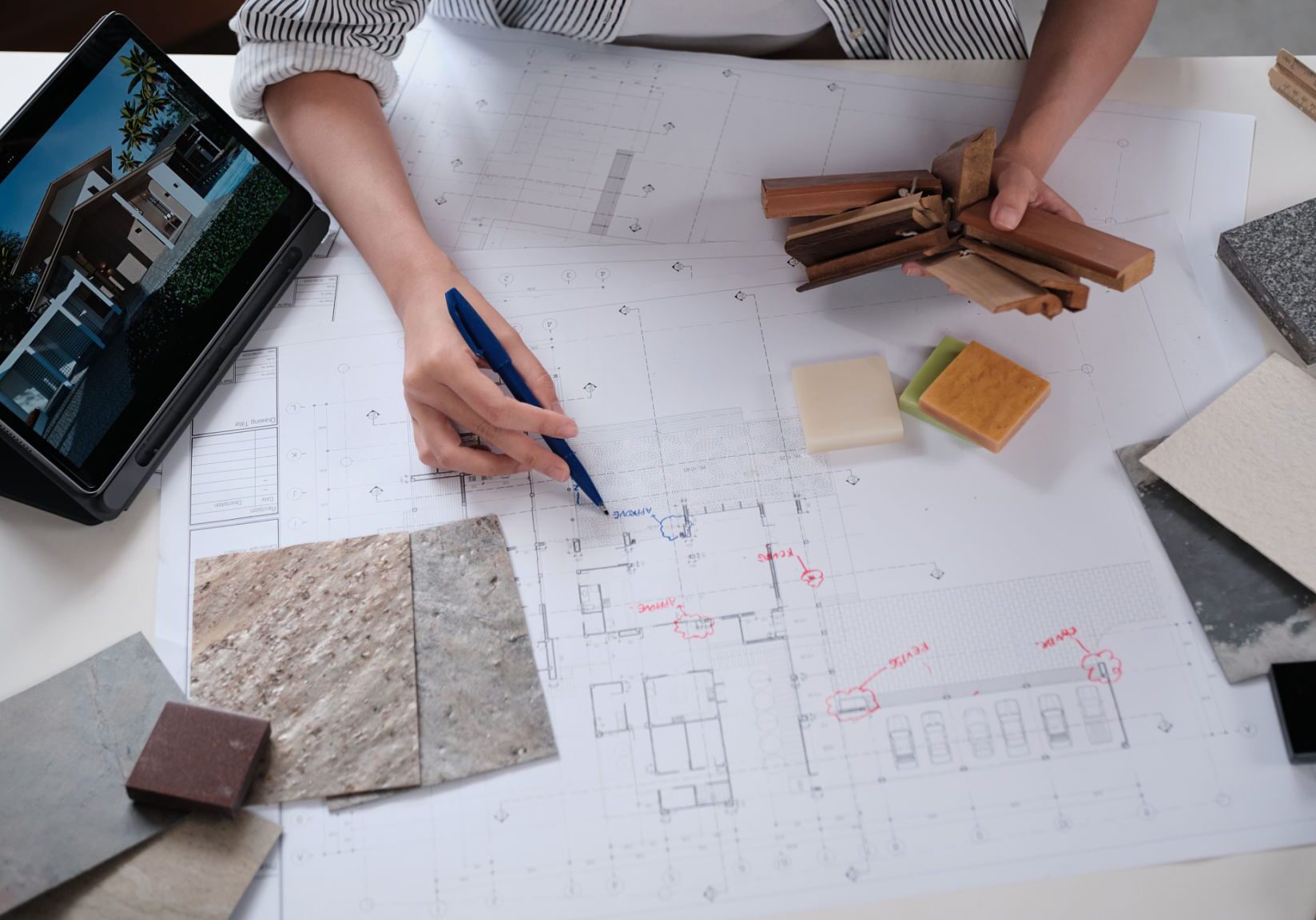 Architect planning with blueprints and materials.